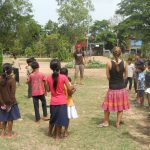 volunteers playing with students